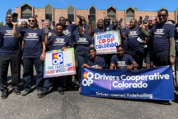 Group of rideshare drivers holding up cell phones