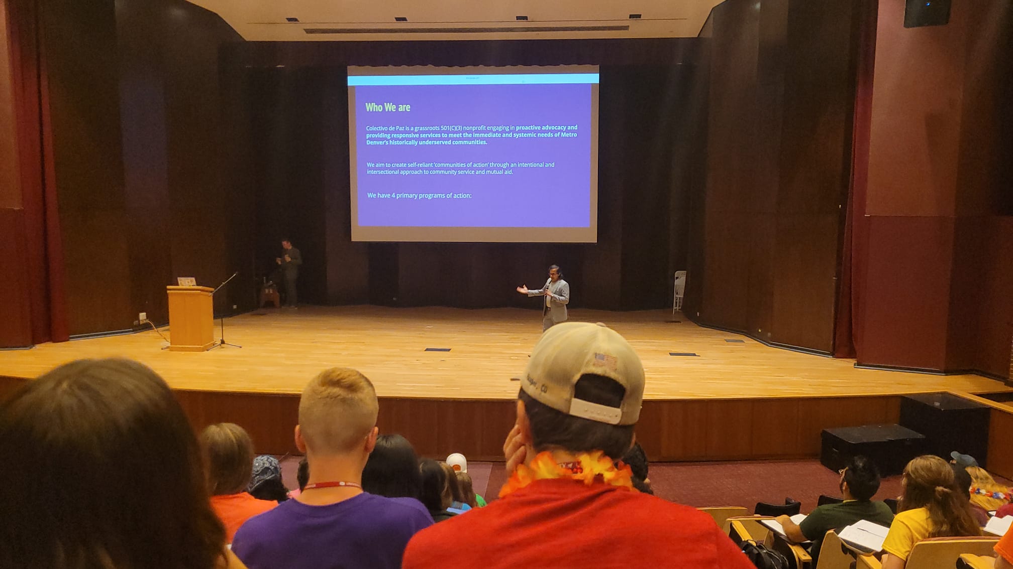 Auditorium with speaker presenting at front of room