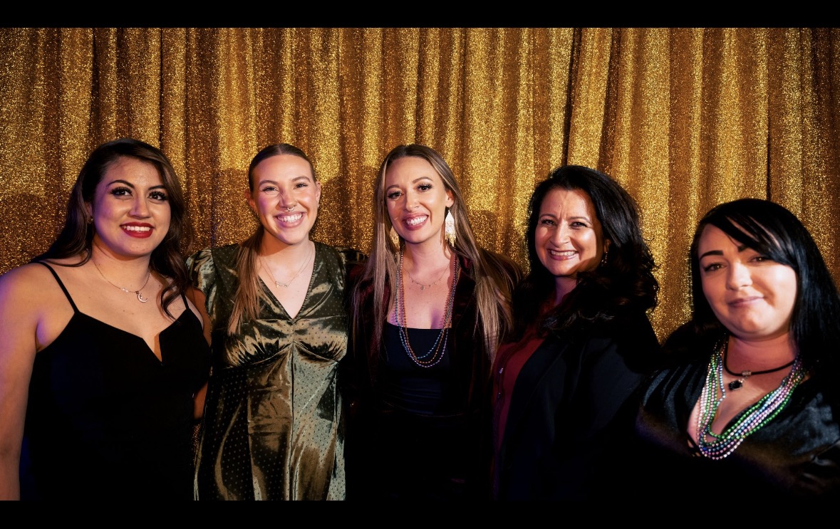 Group of 5 women pose for a photo