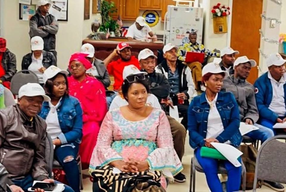 Group of African people sit together in a community meeting room